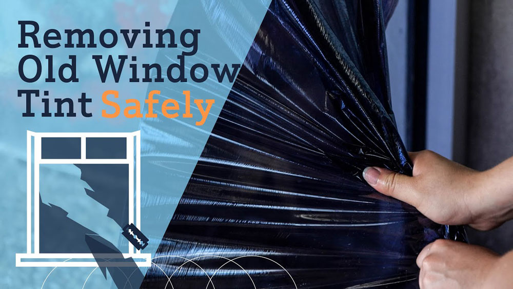Technician carefully removing old window tint from a large glass window